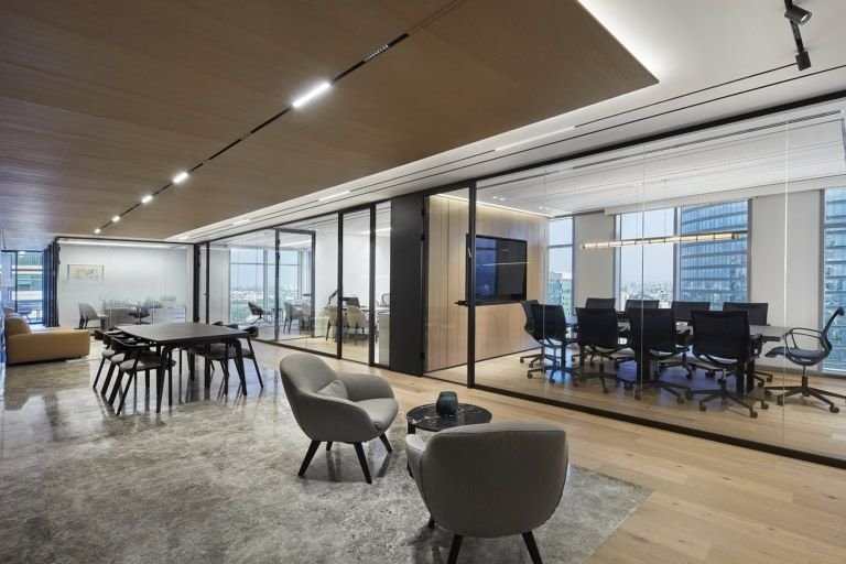 Thoughtfully designed office with glass partitions and collaborative meeting areas